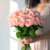 Elegant pink roses in a hand-tied bouquet, perfect to send as a gift