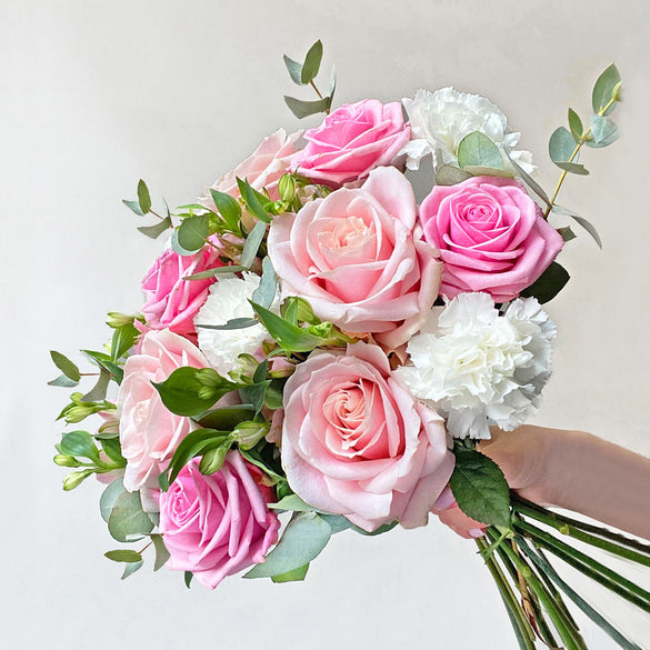 Mixed flower bouquet with pink roses and eucalyptus