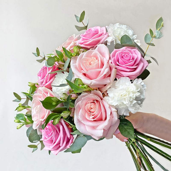 Pastel pink flower bouquet with roses, carnations and eucalyptus
