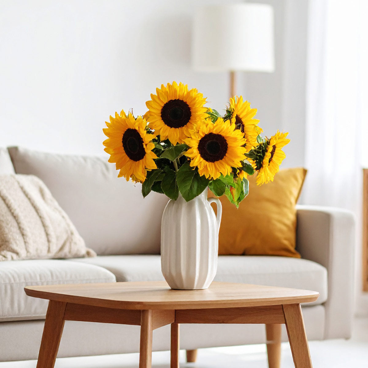 Bright yellow sunflowers arranged in a vase – cheerful British-grown blooms